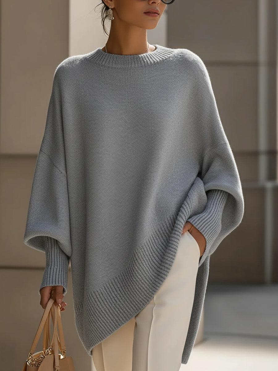 Dam poncho i olivgrön med moderna fladdermousärmar och draperad siluett